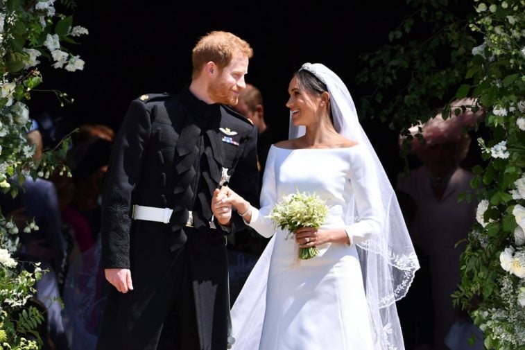 Britain's Prince Harry, Duke of Sussex and his wife Meghan, Duchess of Sussex leave from the West Door of St George's Chapel