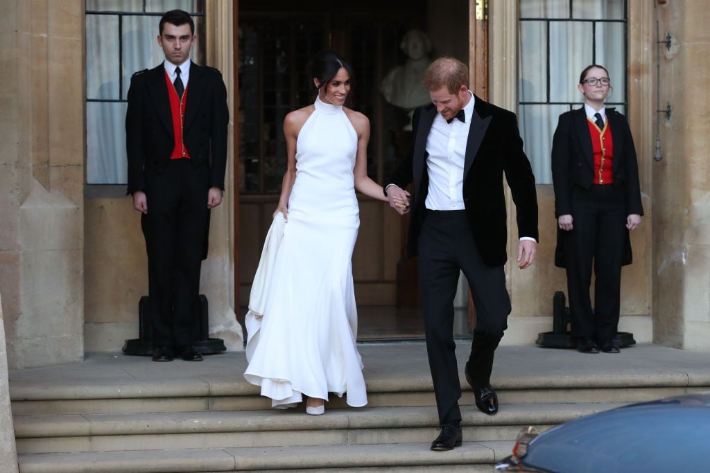Duchess of Sussex and Prince Harry, Duke of Sussex leave Windsor Castle after their wedding to attend an evening reception at Frogmore House