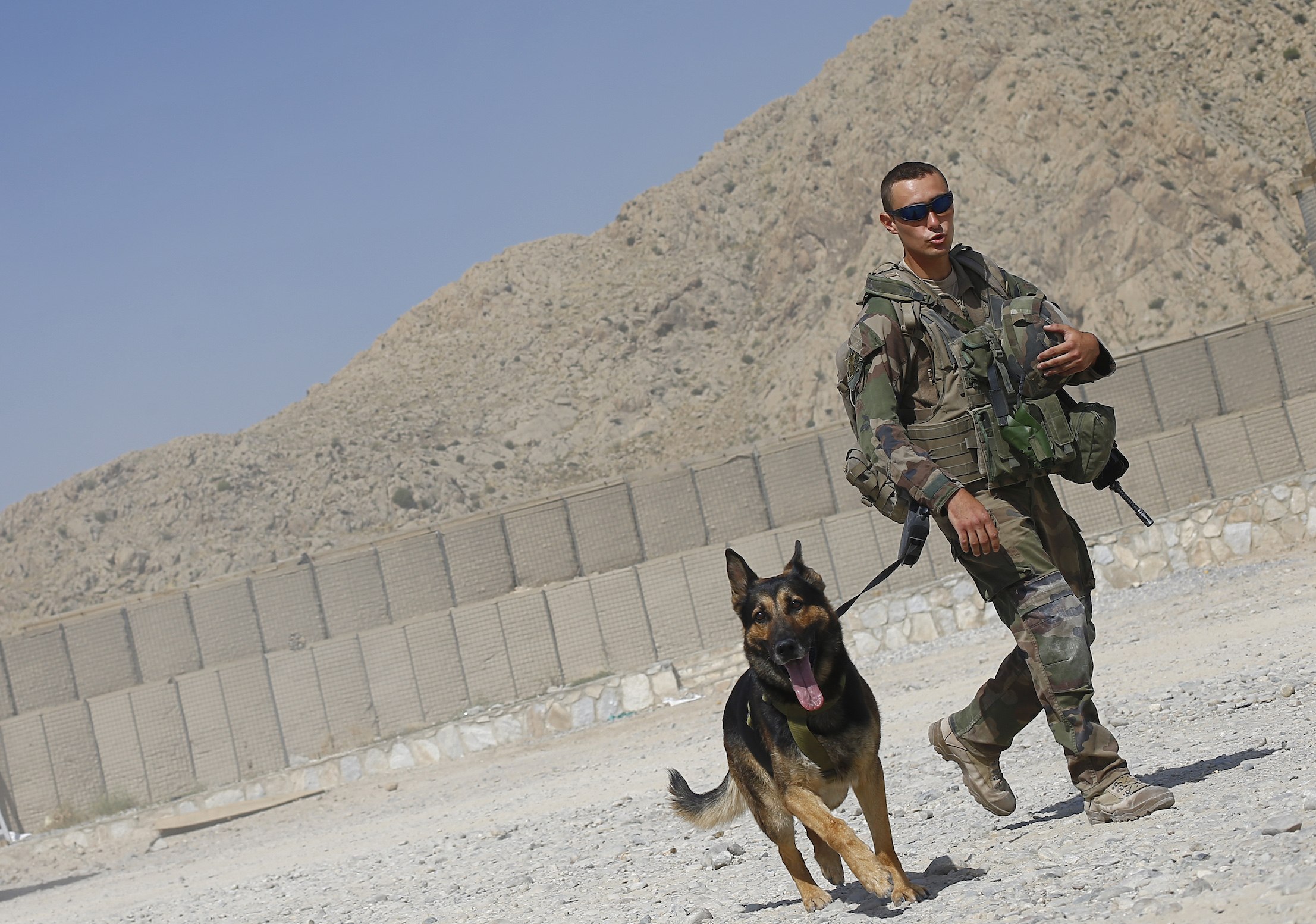 A French soldier from the 92eme Regiment walks his attack dog