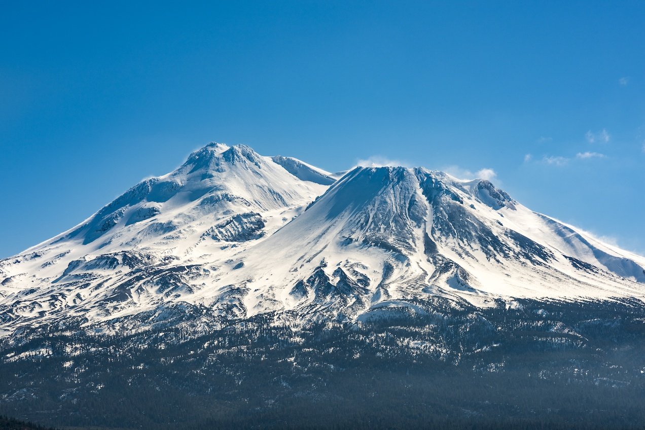 Snowcapped Mount Shasta volcano during winter blue closeup