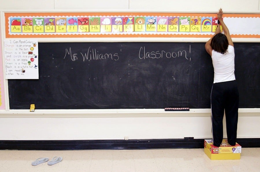 Ckaris Williams, a teacher and Hurricane Katrina evacuee, prepares her classroom