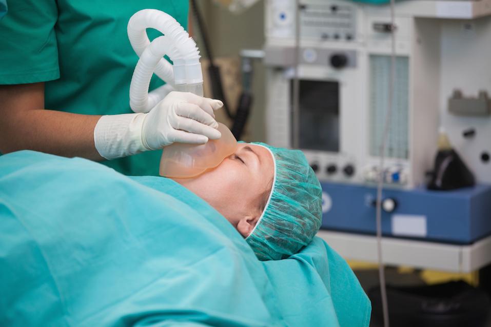 Nurse putting an oxygen mask