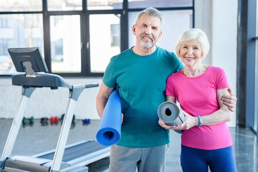 Old couple with yoga mat