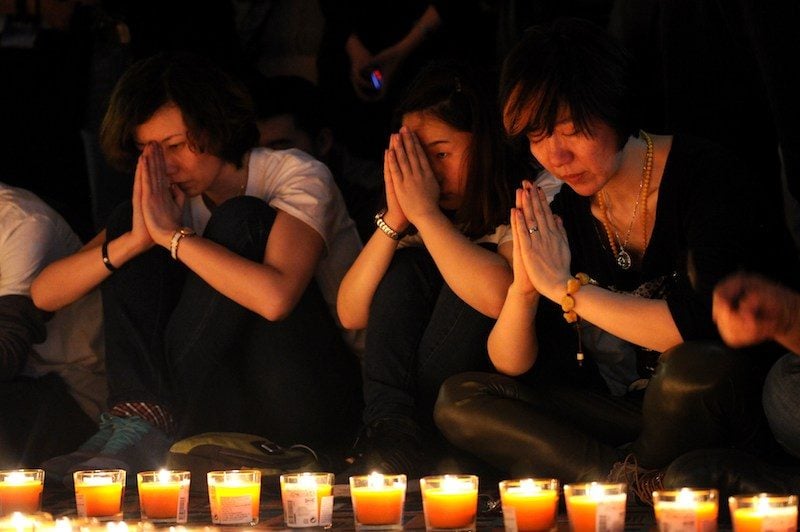 Chinese relatives of passengers on the missing Malaysia Airlines flight MH370 take part in a prayer service at the Metro Park Hotel in Beijing