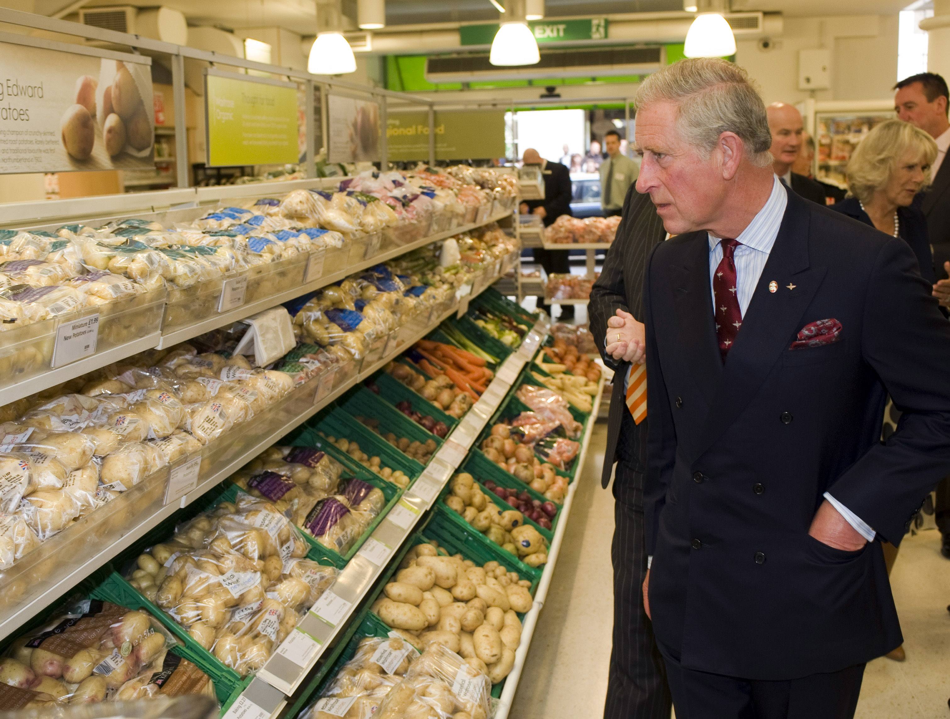 Prince Charles looking at vegetables in grocery store