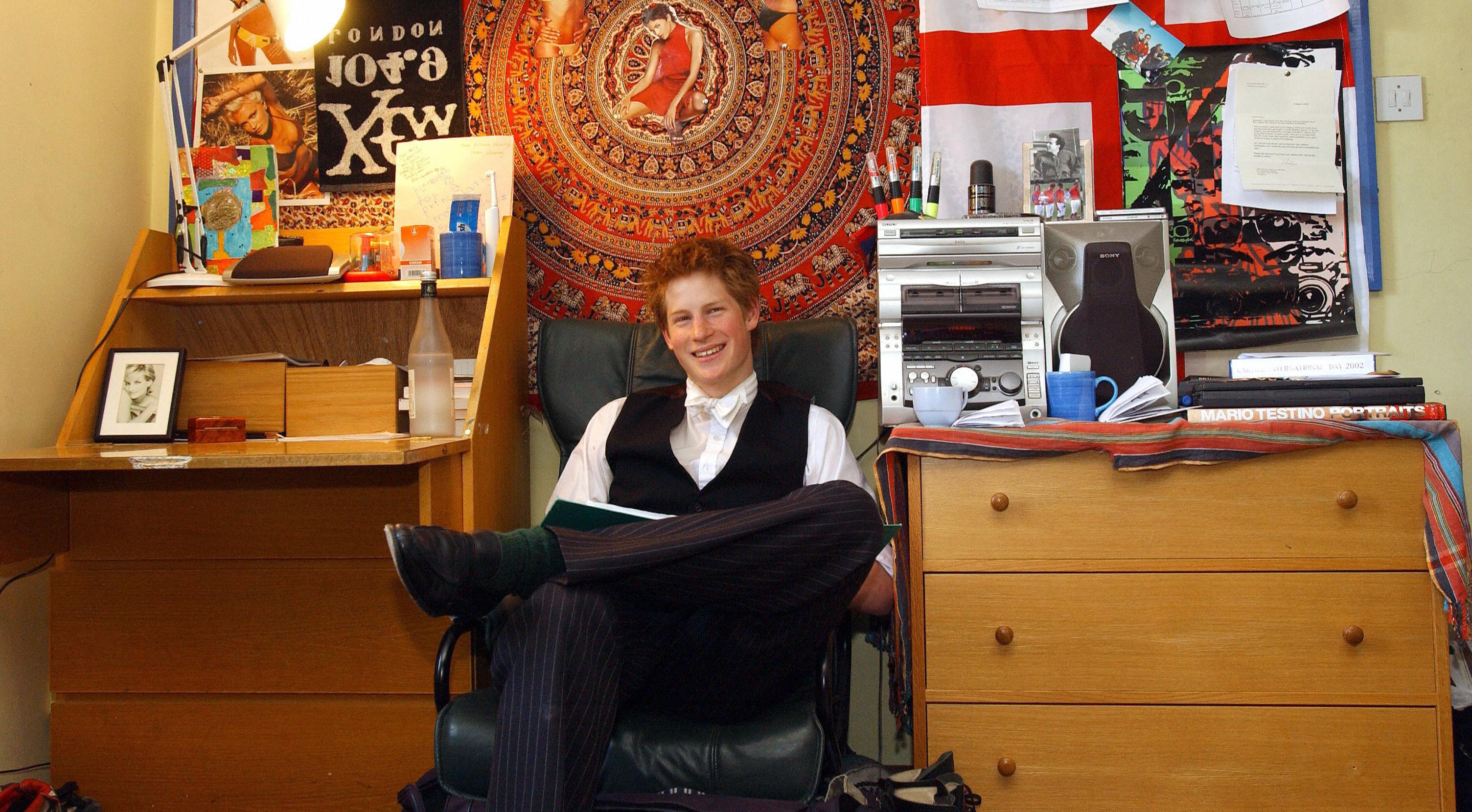 Prince Harry, the younger son of the Prince of Wales, sits 12 May 2003 in his room at Eton College. Within limits, students are allowed to decorate their room themselves.