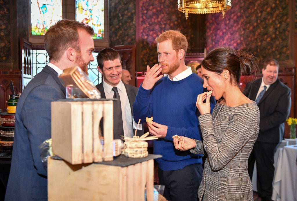 Prince Harry and Meghan Markle taste traditional Welsh cakes during a visit to Cardiff Castle
