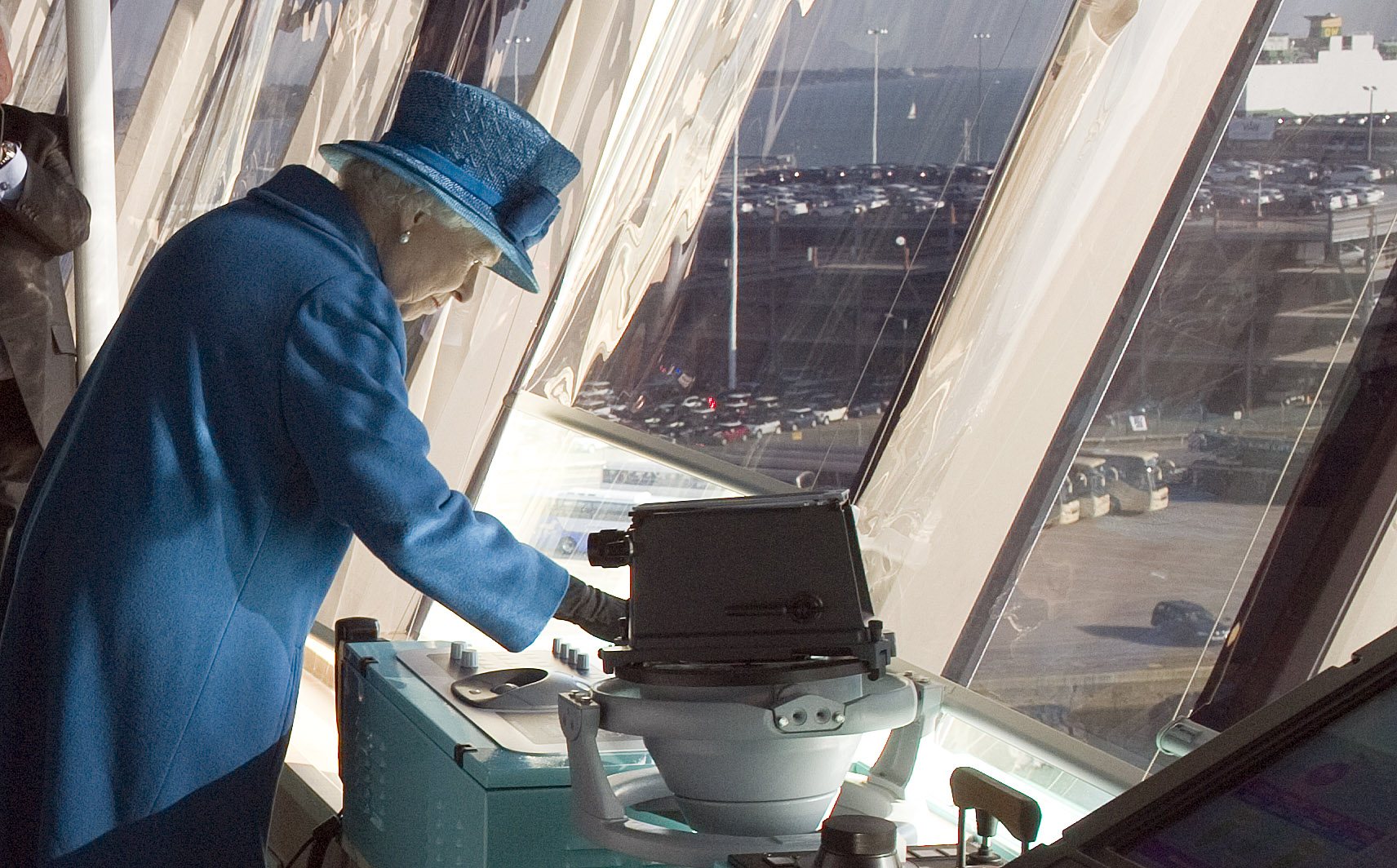 Queen Elizabeth II presses the ship's siren during a tour of the Cunard's new cruise-liner Queen Elizabeth II