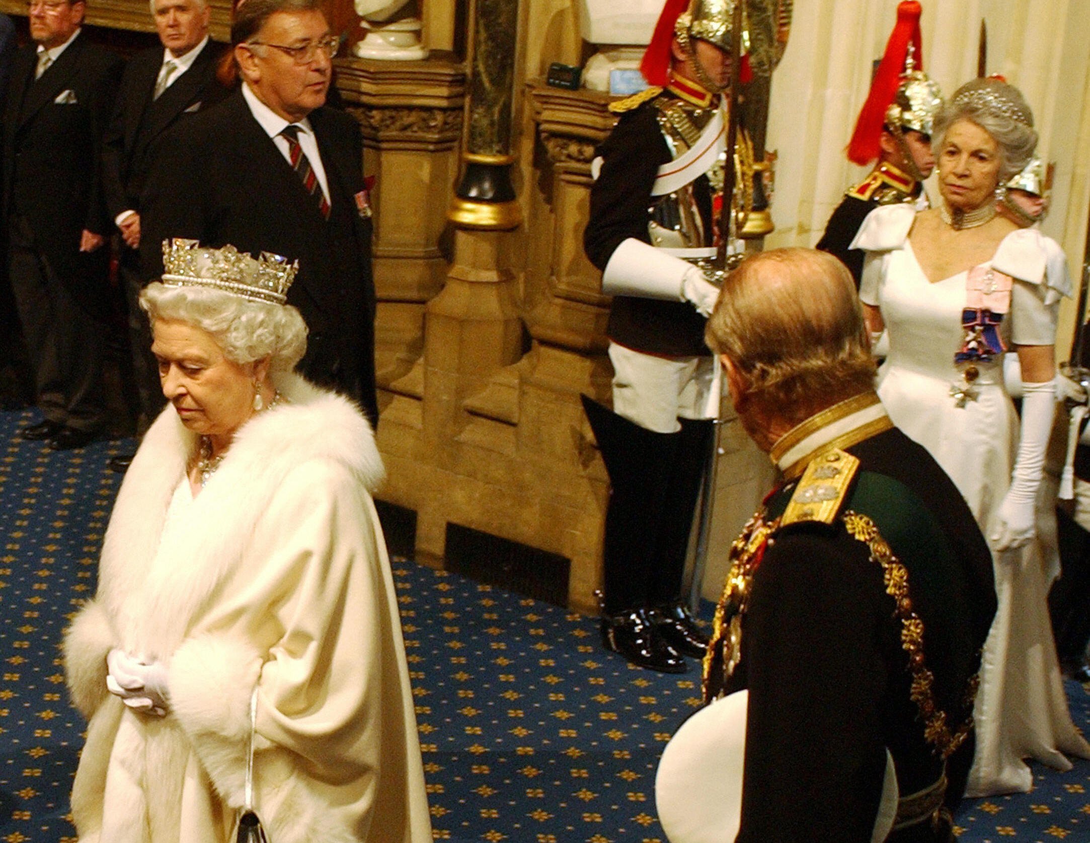 Queen Elizabeth II arrives on the Norman Porch as Prince Phillip looks back to a lady in waiting