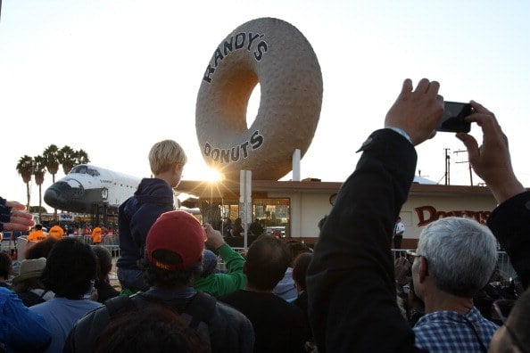A crowd gathers outside of Randy's Donuts to watch the space shuttle Endeavour A crowd gathers outside of Randy's Donuts to watch the space shuttle Endeavour