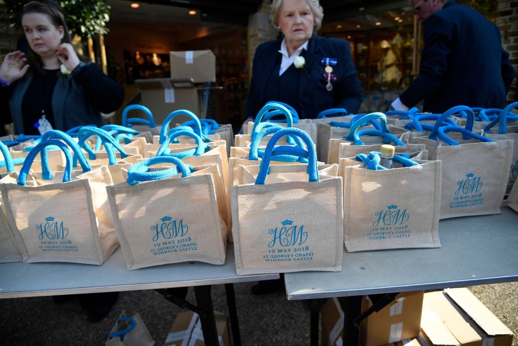 A member of staff holds bags with the wedding monogram ahead of the wedding ceremony of Britain's Prince Harry, Duke of Sussex and US actress Meghan Markle in Windsor, on May 19, 2018.
