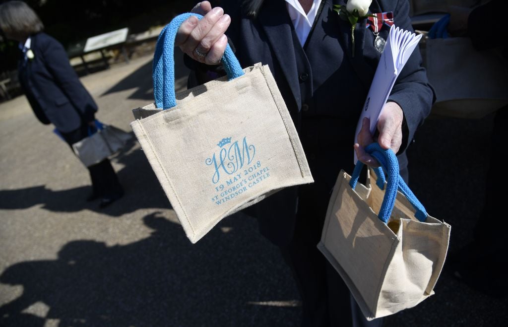 A member of staff holds bags with the wedding monogram ahead of the wedding ceremony of Britain's Prince Harry, Duke of Sussex and US actress Meghan Markle