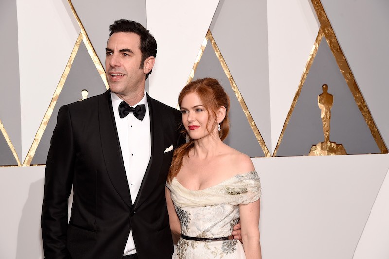 Sacha Baron Cohen and Isla Fisher on a red carpet. 