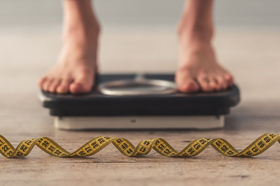 Woman standing on a scale Woman standing on a scale