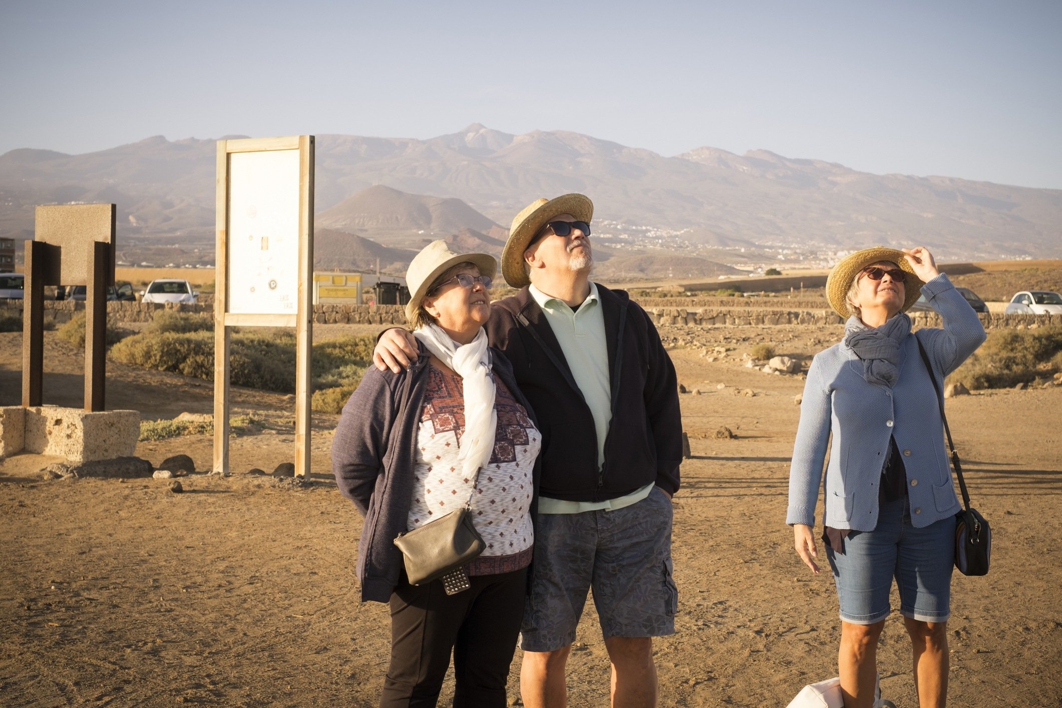 group of senior adult caucasian looking something in the air in a sunny day
