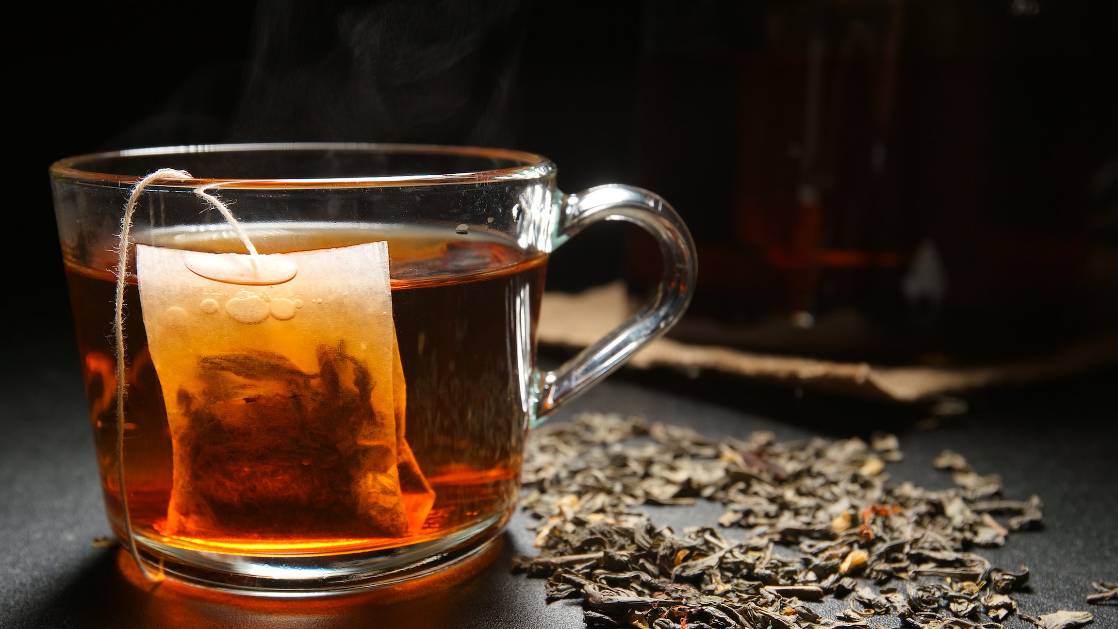 Tea bag in a hot tea cup on a table