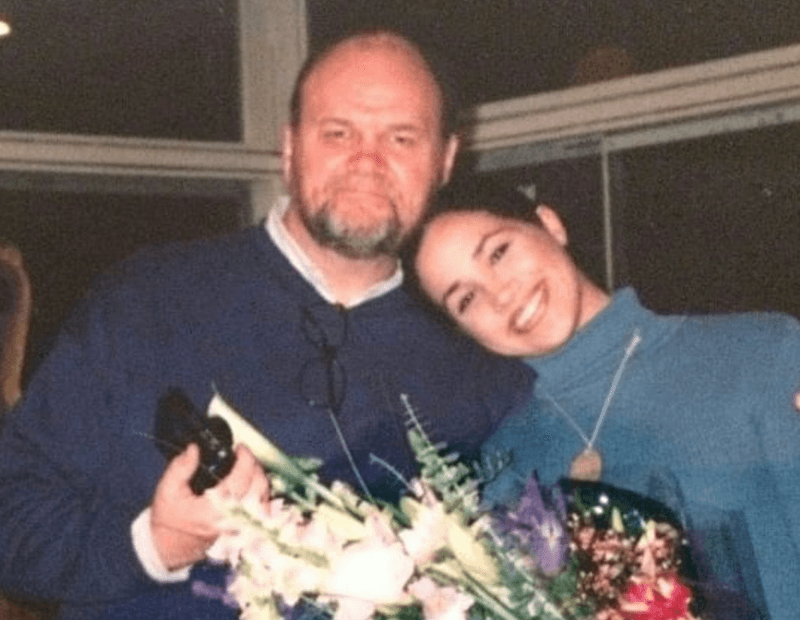 A young Meghan Markle smiling with her father. 