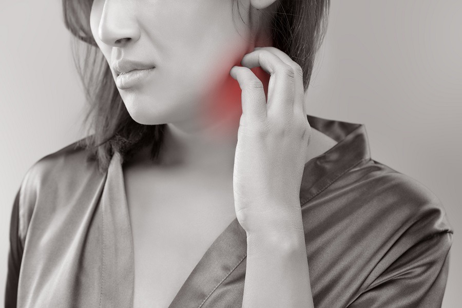 Woman scratching her neck Woman scratching her neck