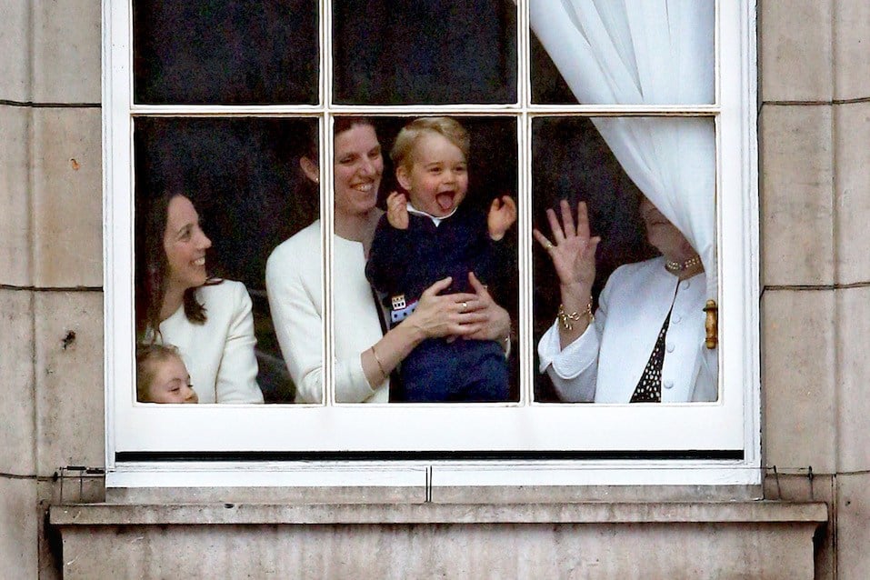 Prince George looks through a window in Buckingham Palace prior to the Trooping The Colour ceremony