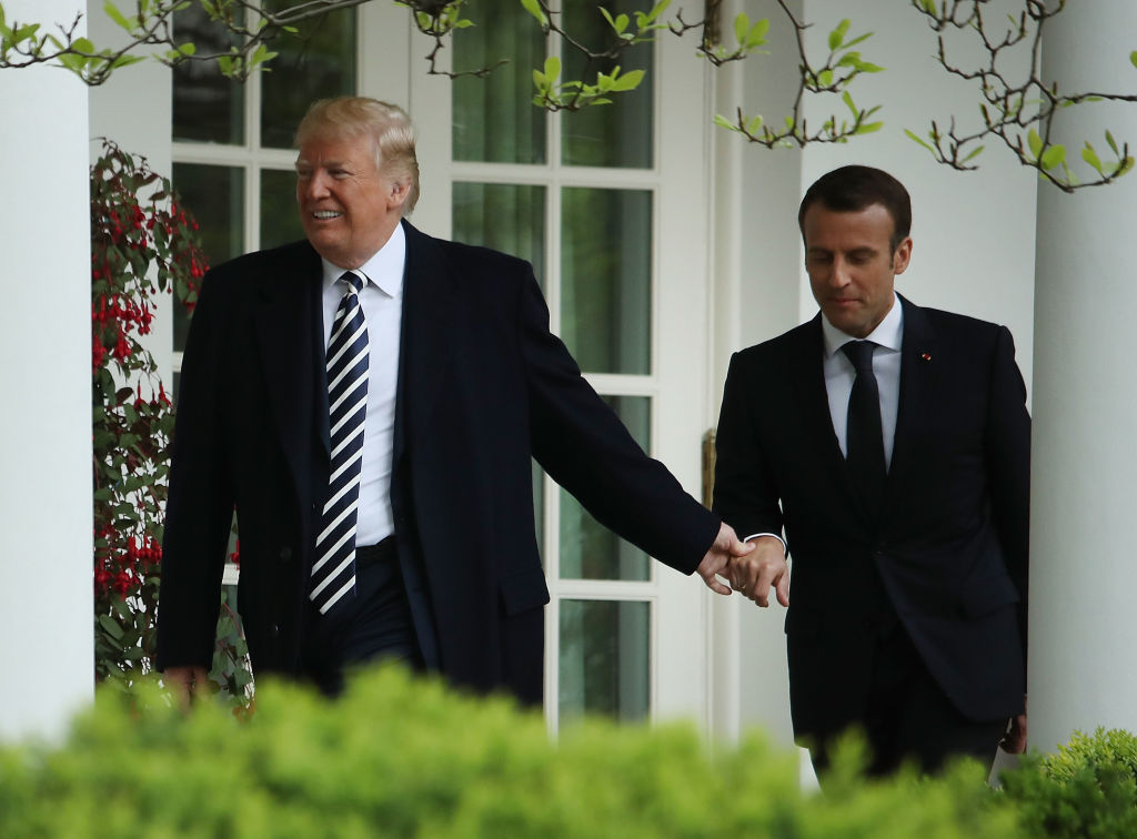 Trump and Macron holding hands