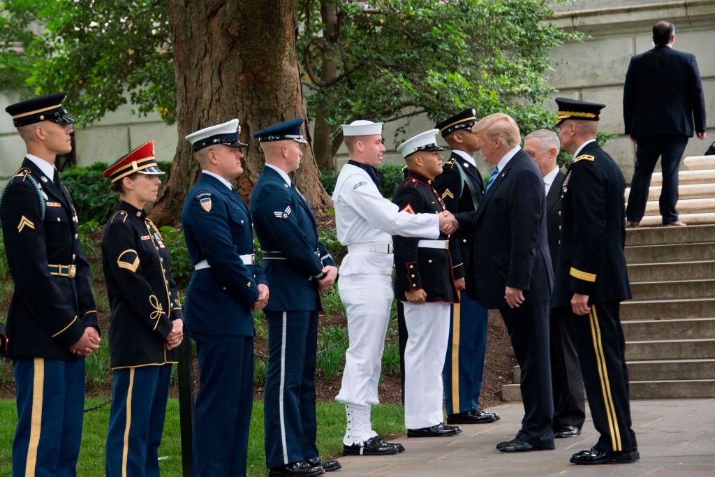 US President Donald Trump shakes hands with members of the military
