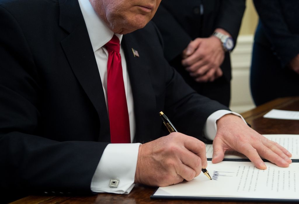 US President Donald Trump signs an executive order with small business leaders