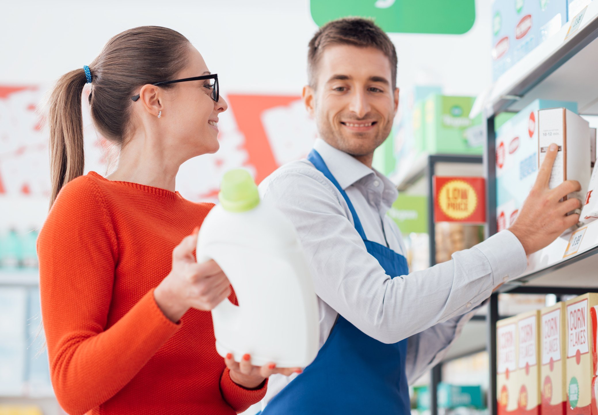 Supermarket clerk helping a customer