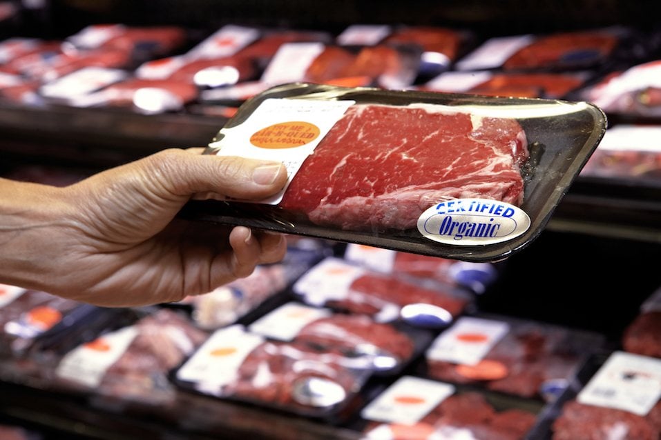 men buying meat in grocery store