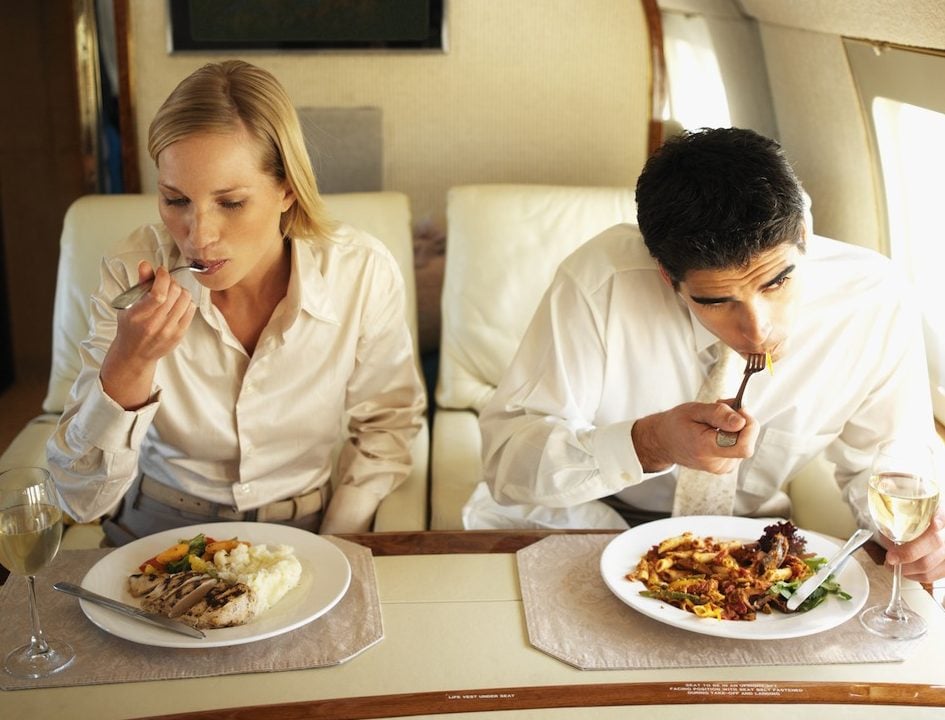 customers eating and drinking while on an airplane customers eating and drinking while on an airplane