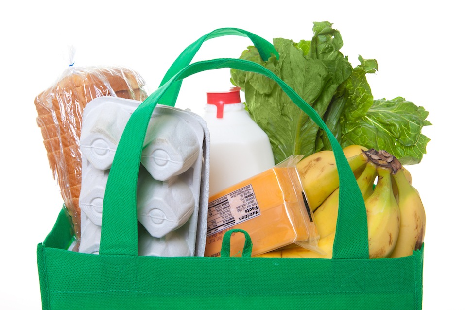 groceries in a green reusable shopping bag