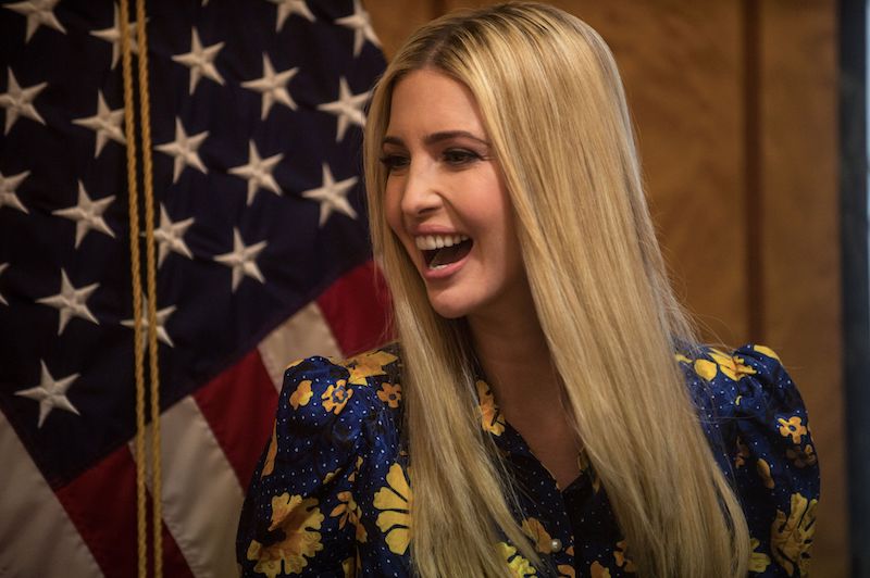 Ivanka Trump laughing in front of an American flag. 