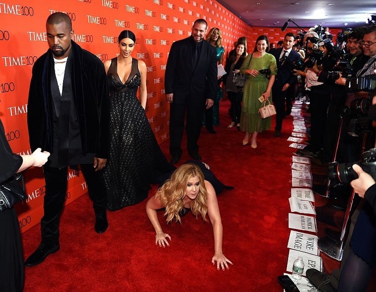 Kanye West. Kim Kardashian, and Amy Schumer on a red carpet Kanye West. Kim Kardashian, and Amy Schumer on a red carpet
