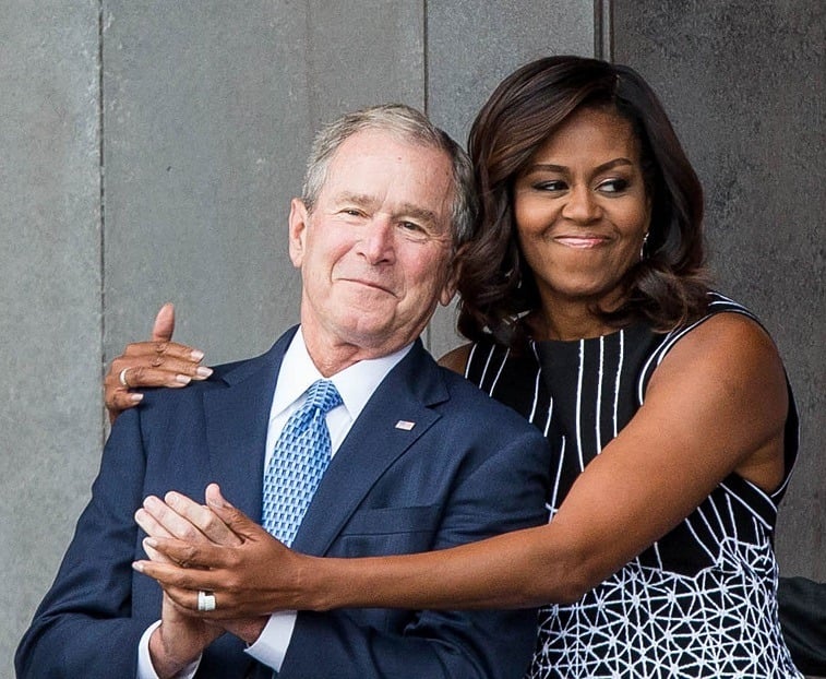 Former US President George W. Bush receives a hug from US First Lady Michelle Obama as they attend the opening ceremony for the Smithsonian National Museum of African American History and Culture on September 24, 2016 in Washington, D.C. Former US President George W. Bush receives a hug from US First Lady Michelle Obama as they attend the opening ceremony for the Smithsonian National Museum of African American History and Culture on September 24, 2016 in Washington, D.C.