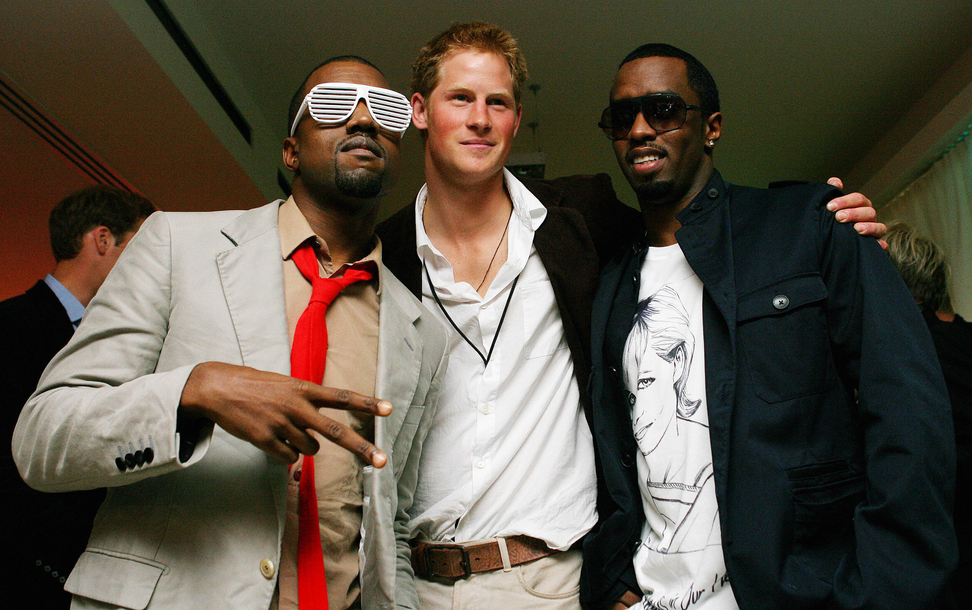 Kanye West poses with Prince Harry and Diddy at Wembley Arena in north London, 01 July 2007