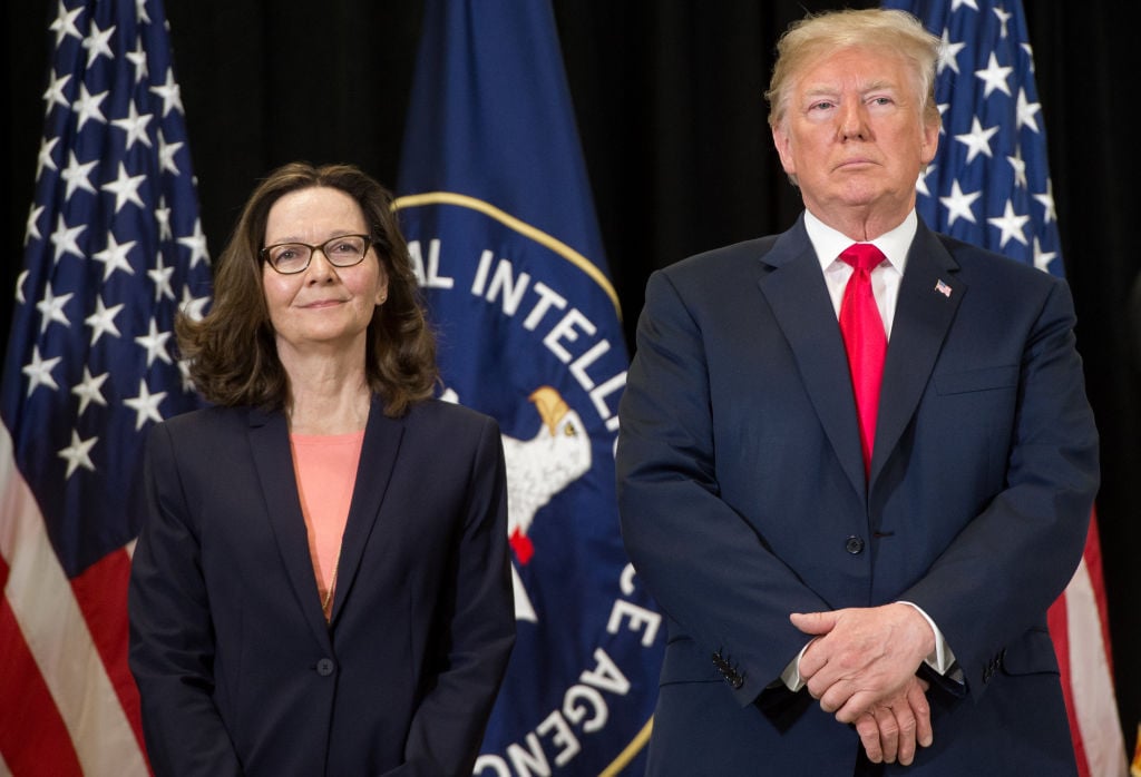 US President Donald Trump stands alongside Gina Haspel