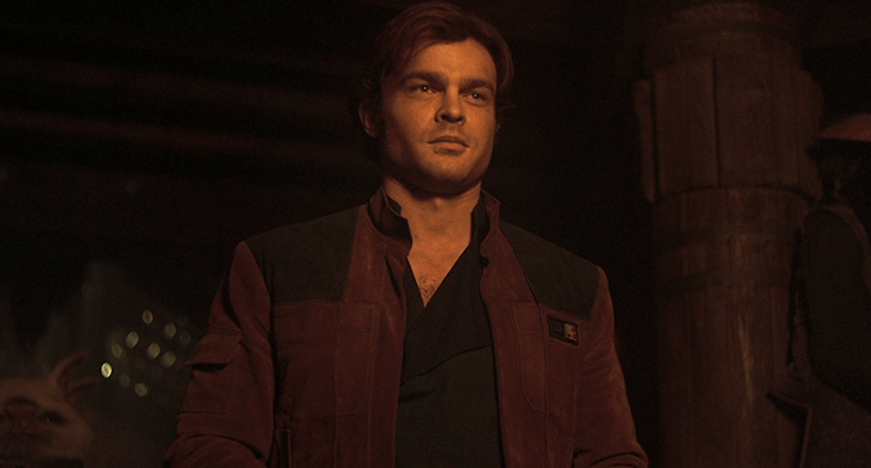Han standing in a dark room.
