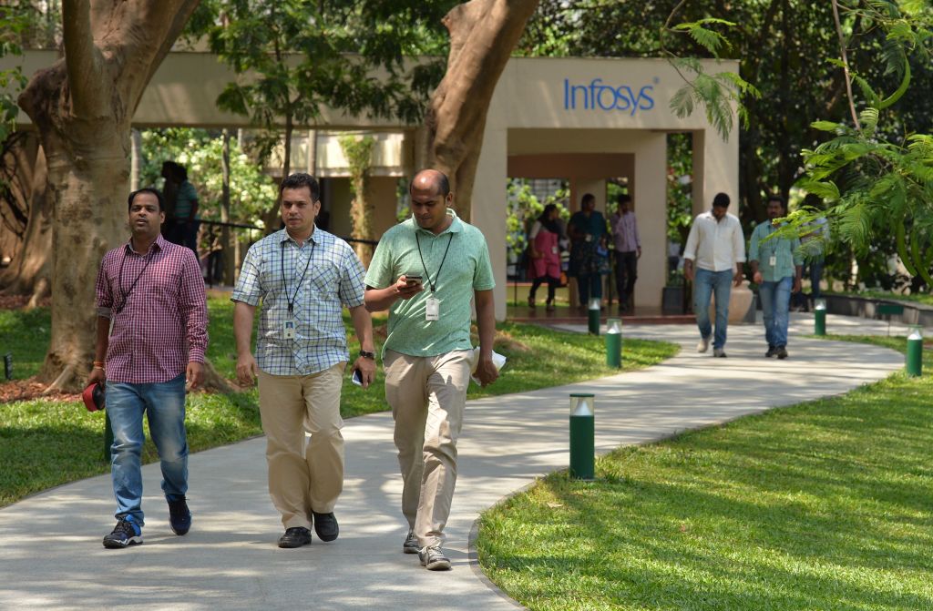 Employees of Infosys Technologies Limited walk in the campus