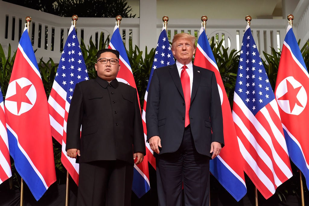US President Donald Trump (R) poses with North Korea's leader Kim Jong Un