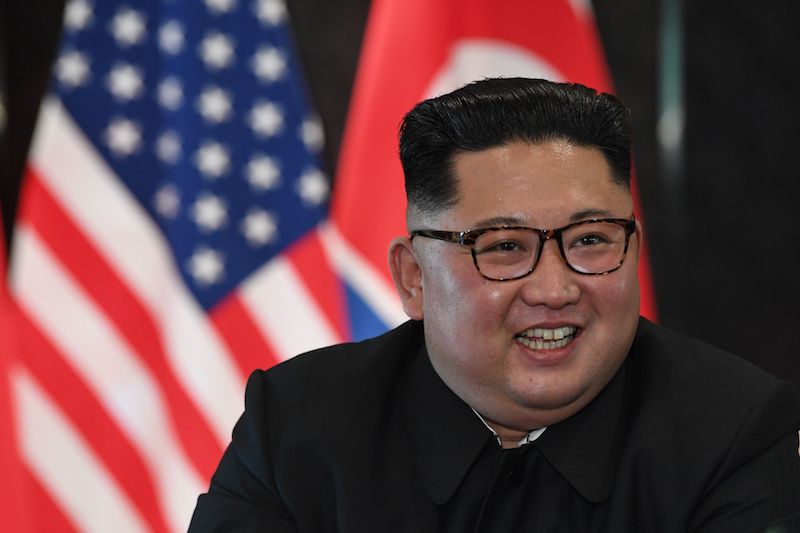 North Korea's leader Kim Jong Un reacts at a signing ceremony with US President Donald Trump 
