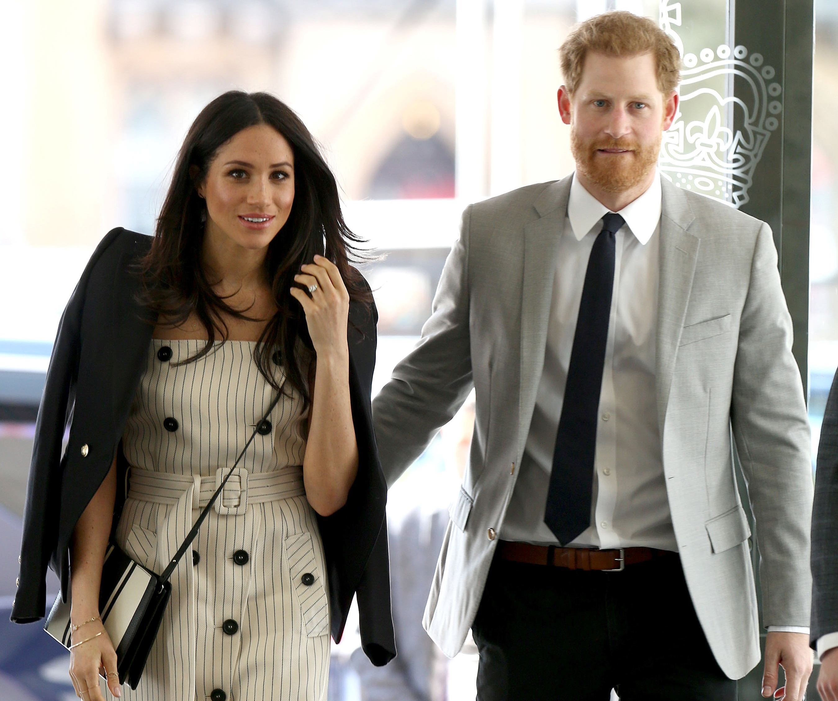 Britain's Prince Harry (R) and his fiancee US actress Meghan Markle, arrive to attend a reception with delegates from the Commonwealth Youth Forum