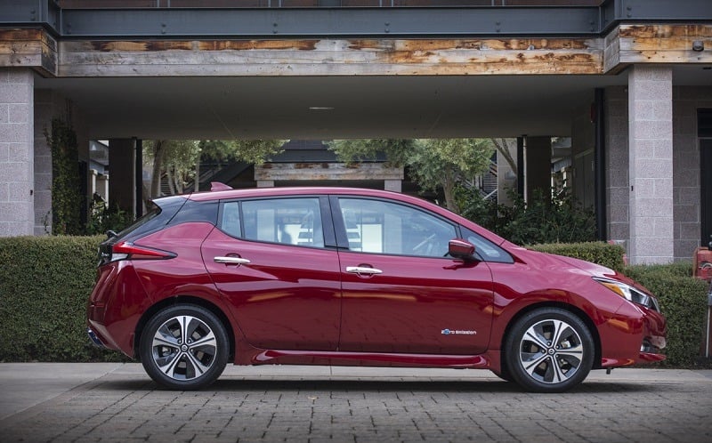 A red 2018 Nissan Leaf in profile