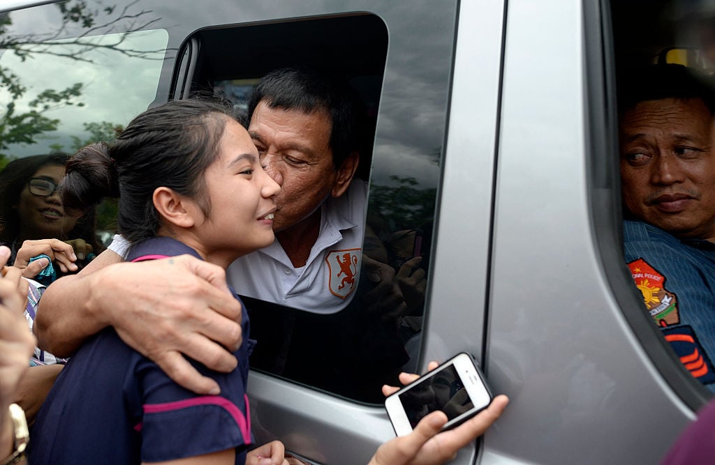 Rodrigo Duterte kissing a fan