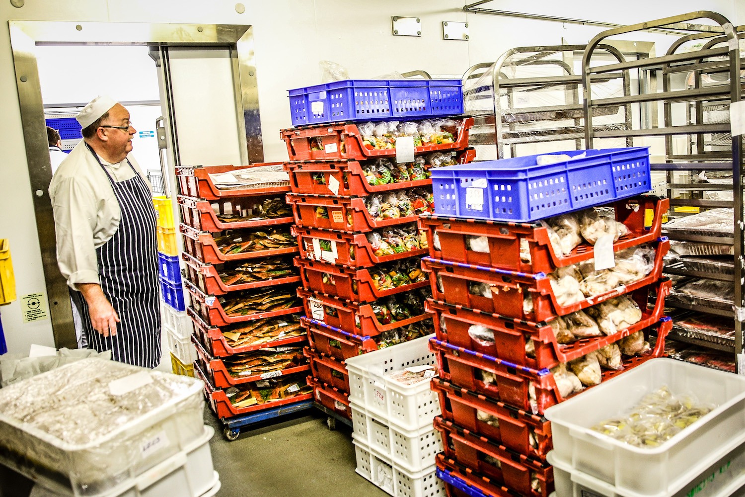 A chef collects ingredients from a cold store in the general kitchen during day four of Royal Ascot
