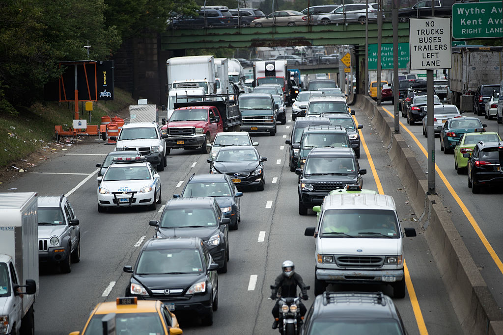 Traffic crawls on the Brooklyn-Queens Expressway (I-278), July 1, 2016 in the Brooklyn borough of New York City. Officials from the American Automobile Association (AAA) are predicting 44 million people will travel by roads, airports, buses, and train this holiday weekend. Gas prices for the July 4th weekend are the lowest they've been in 11 years.