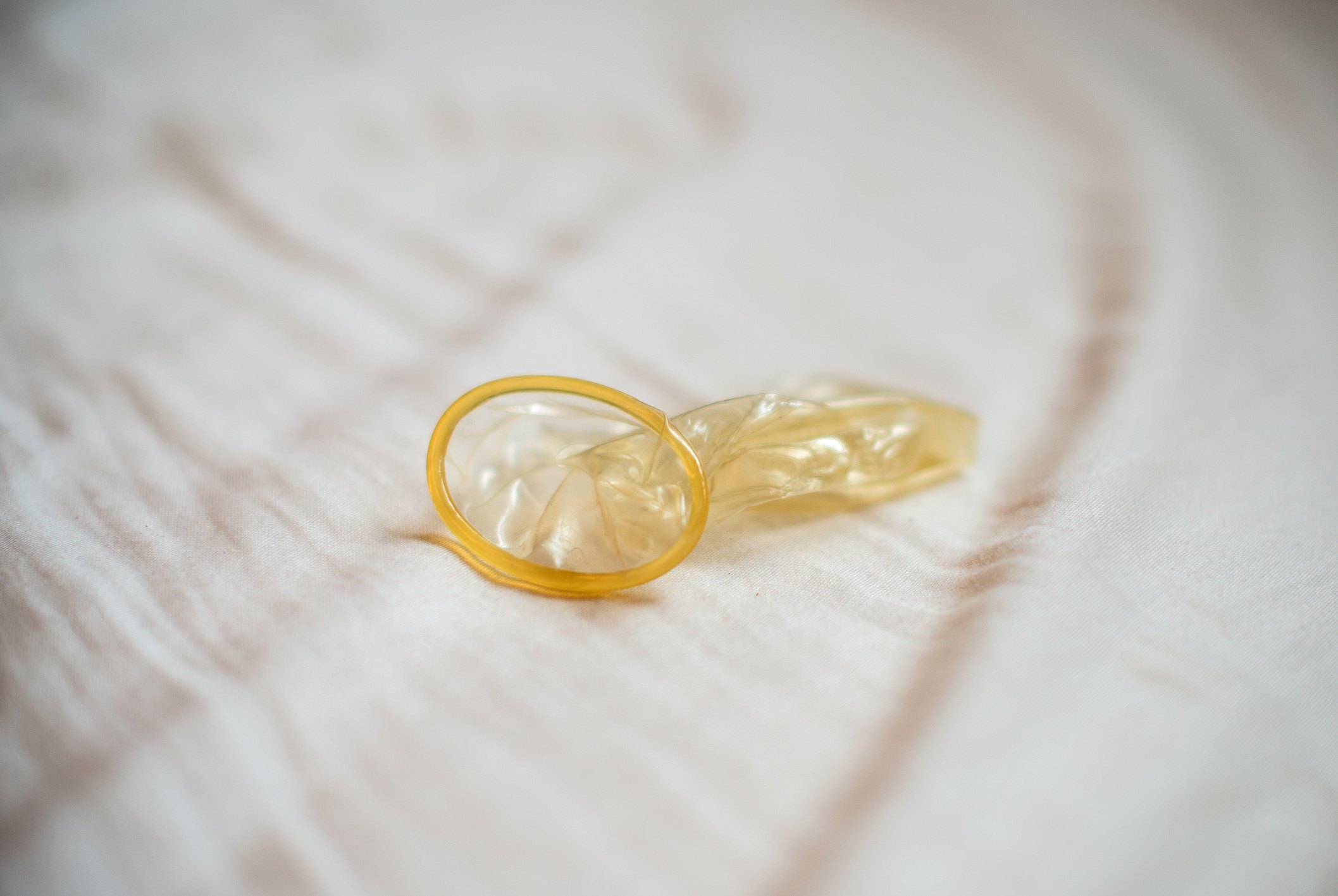 Condom left on a hotel bed