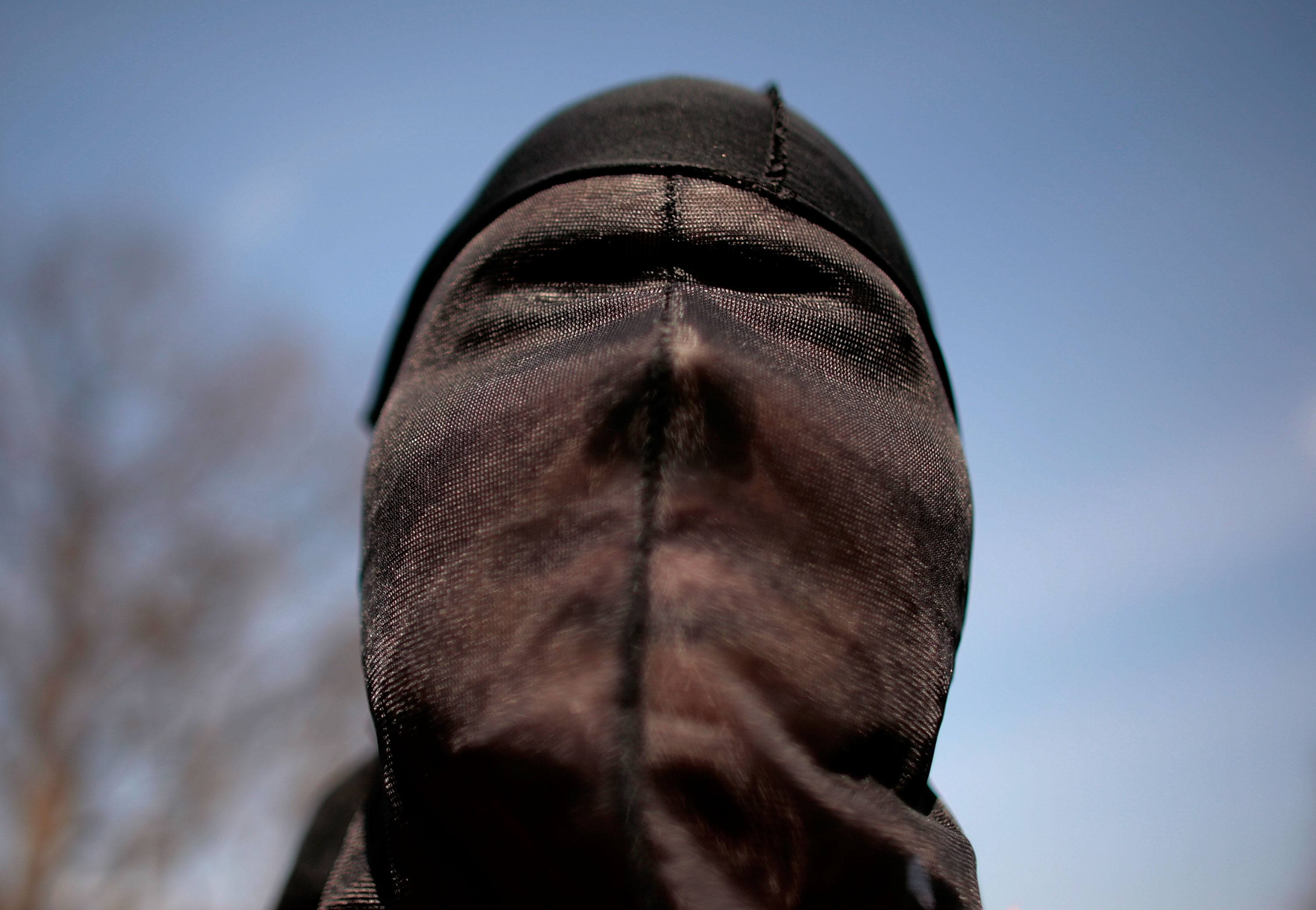 A demonstrator dresses as a "detainee" during a rally to "demand Congressional action to stop torture"