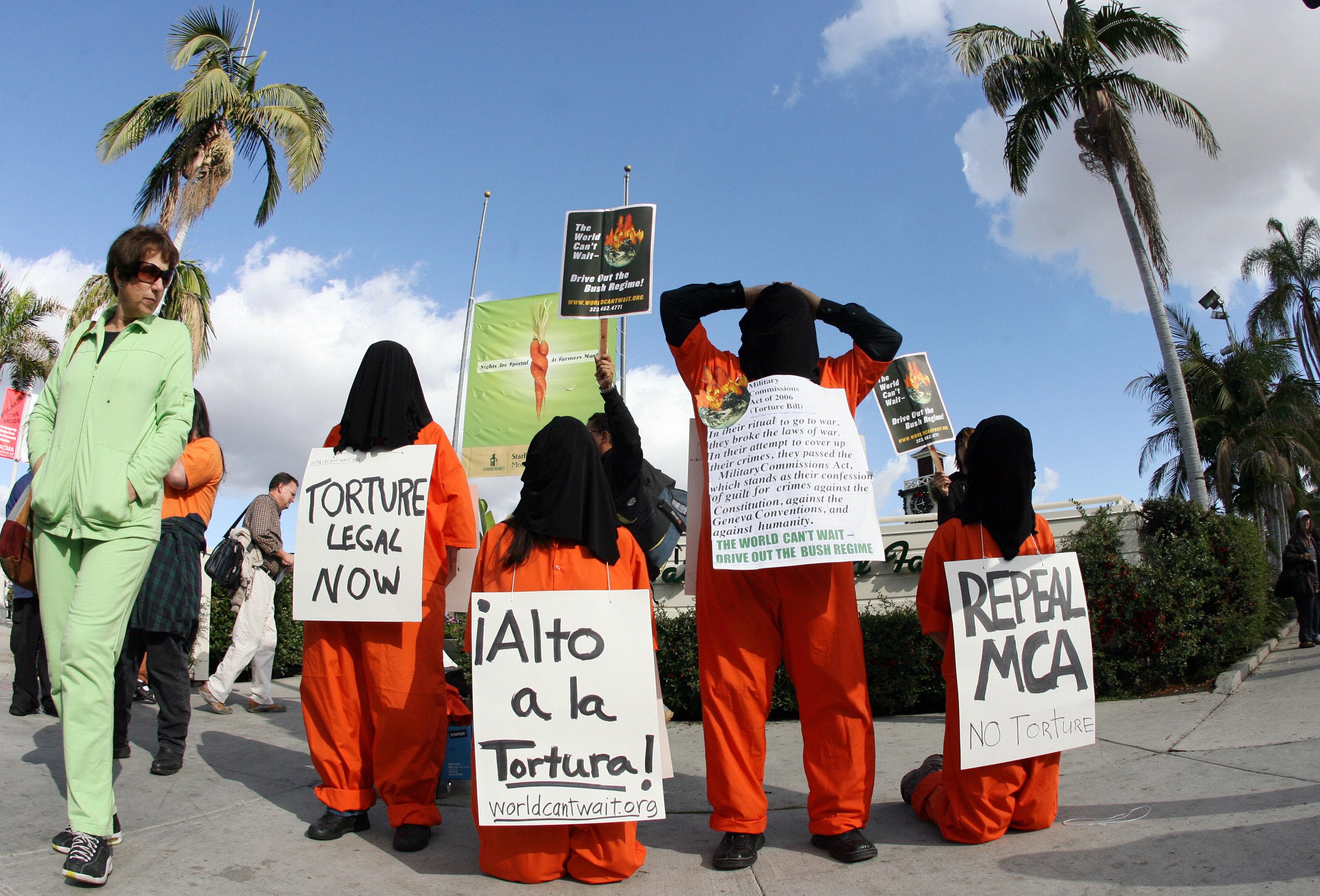 Demonstrators dressed as Guantanmo priso
