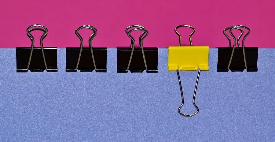 A row of black binder clips A row of black binder clips