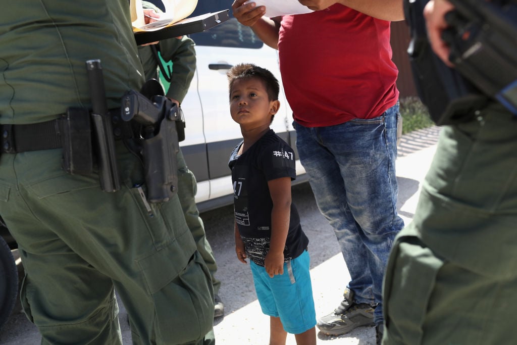 A boy and father from Honduras are taken into custody by U.S. Border Patrol agents near the U.S.-Mexico border.