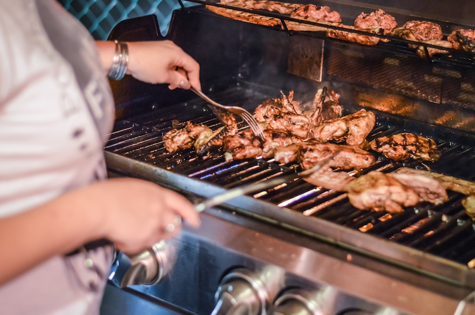 Woman lighting a gas grill Woman lighting a gas grill